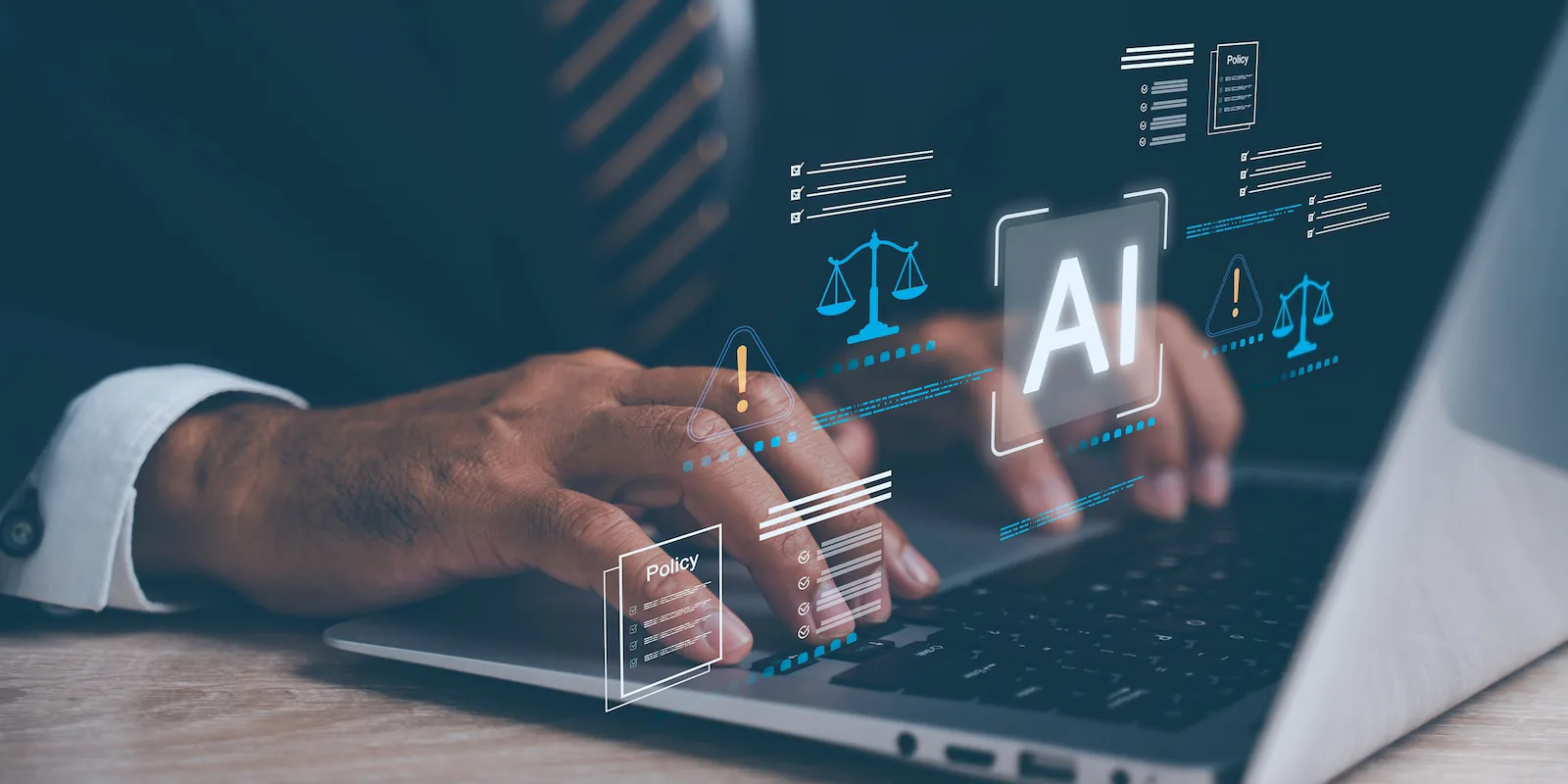 Hands typing on a laptop, with icons for AI and legal policy over the keyboard